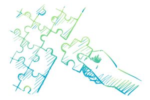 A hand placing a puzzle piece into a larger puzzle.